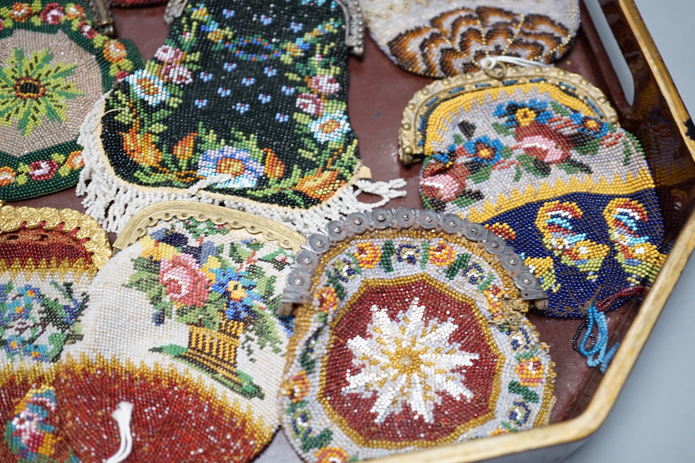 Twenty mid-19th century Berlin beadwork purses with gilt-metal frames, largest 10cm